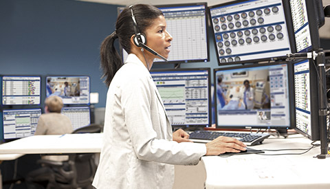 (opens in a pop-up) Clinician monitoring patients with maximized ICU capabilities